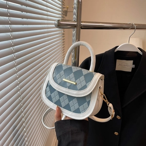 Minimalist argyle saddle bag in blue and white leather featuring gold metal clasp