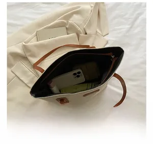 Top view of large canvas tote bag interior showing capacity for phone, wallet and umbrella