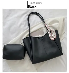 Close-up of black tote bag set with a polka dot silk scarf and inner zipper pouch