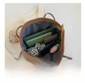 Top view of spacious interior with tablet and cosmetics inside a brown tote bag