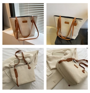 Detail view showing beige canvas tote bag with brown faux leather trim and fashion tag