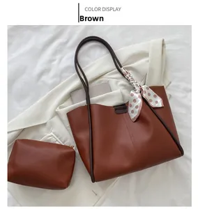 Top view of brown leather tote bag set with polka dot silk scarf and inner pouch