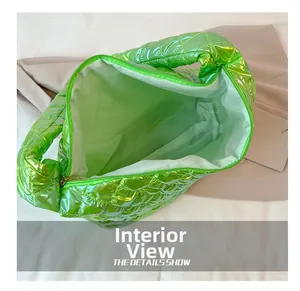 Interior view showing the large capacity and green nylon lining of this quilted tote bag