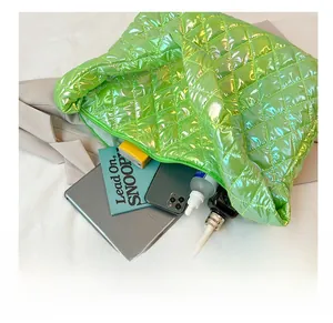 Interior view of large neon green cloud bag showing spacious capacity for tablets and books