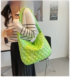 Detailed view of neon green quilted tote bag with metallic finish and wide shoulder strap