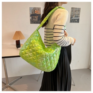 Detail view of neon green quilted large tote bag with stylish pleated cloud shape design
