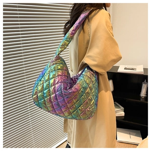 Detailed side view of large holographic quilted tote bag with metallic sheen and wide strap