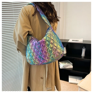Detailed shot of large quilted crossbody bag with iridescent metallic finish on model