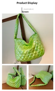 Detail view of large green quilted shoulder bag with shiny metallic finish and spacious design