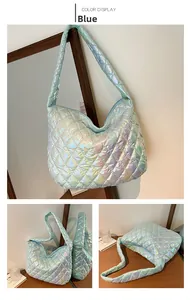Detail view of large quilted tote bag in holographic blue with rhombic pattern