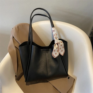 Retro black large tote bag with silk scarf detail on a white chair with khaki trench coat
