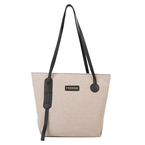 Minimalist canvas tote bag in off-white with black leather straps and gold fashion logo