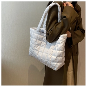 Side view of white quilted down tote bag with plush texture and large capacity