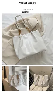 Détail du cabas blanc en cuir souple montrant les anses en chaîne dorée et sa texture