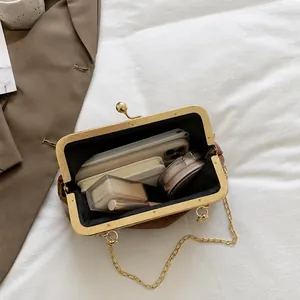 Detail view of the interior capacity of this vintage brown chain bag showing daily items