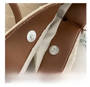 Detail of magnetic snap closure and texture of faux shearling on large tote bag