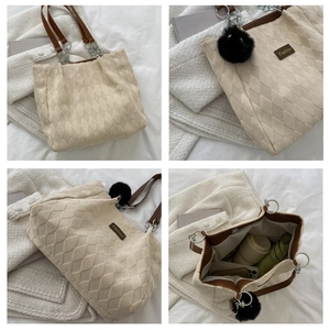 Detail view of large beige quilted tote bag showing interior capacity and chain straps