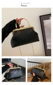 Detailed views of a black crocodile-pattern vintage bag with gold chain and metal handle