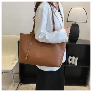 Caramel brown tote bag with quilted texture shown in a professional lifestyle setting