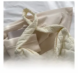 Detail of off-white quilted hobo bag featuring soft texture and spacious interior