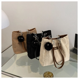 Quilted tote bags in khaki, black, and beige with chain straps and plush charm