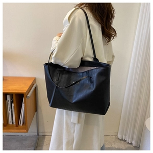 Close-up of a black quilted leather tote bag with dual straps for daily commuting