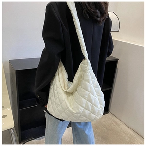 Detailed back view of white quilted dumpling bag with cloud pleated strap on a model