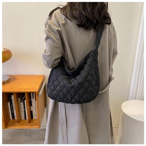 Detailed back view of a black quilted cloud bag showing large capacity and puffy nylon texture