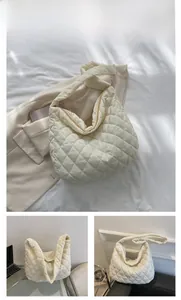Detail of off-white quilted puffer tote bag with large capacity and wide strap