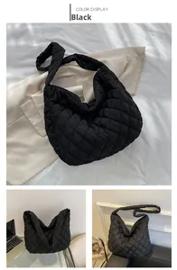 Detail view of large black quilted cloud tote bag in nylon showing soft texture and spacious design