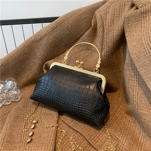 Retro black crocodile leather clutch bag with golden round handle and elegant chain strap