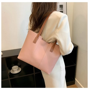 Pink minimalist PU leather tote bag with brown straps and white stitching for daily use