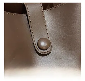 Détail du sac cabas vintage marron avec coutures soignées et texture cuir grainé