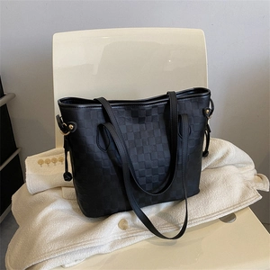 Minimalist black tote bag with checkered texture and leather straps for commuting