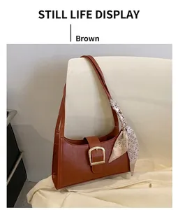 Brown crocodile pattern leather shoulder bag with a silk scarf detail and gold buckle