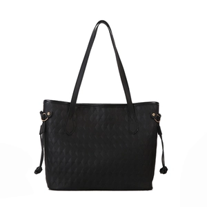 Black woven tote bag with large quilted texture and gold hardware on white background