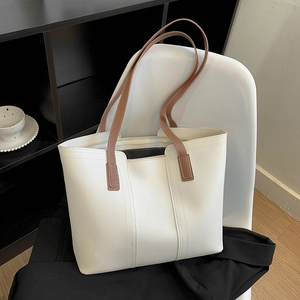 Minimalist large white tote bag with brown straps for daily commute and casual use