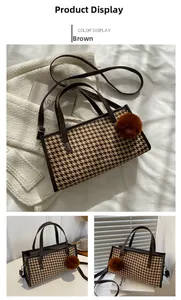 Detailed view of brown houndstooth pattern fabric with elegant faux leather trim and pompom