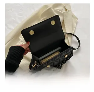 Interior view of black quilted crossbody bag showing space for phone and wallet