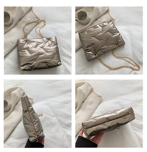 Detailsicht der gesteppten Metallic-Textur und goldene Kettenriemen der Tragetasche