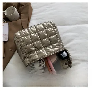 Detail showing the large interior capacity of a champagne gold quilted tote bag