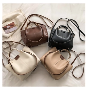 Minimalist tote bags in four classic colors with metal handles on white fabric