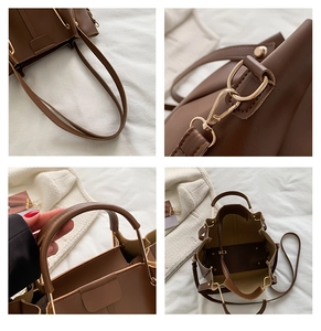 Detailed macro view of dark brown leather bucket bag with elegant gold metal hardware