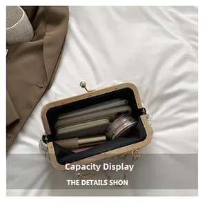 Top-down view of open tweed bag interior showing storage space for phone and makeup