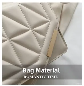 Close-up of quilted cream leather texture and gold metal detail on luxury handbag