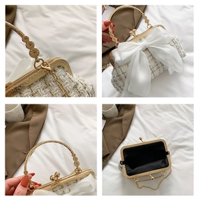 Macro detail of cream tweed handbag with bow, golden metallic handle and chain strap