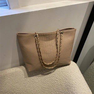 Fashionable apricot tote bag with crocodile embossing and golden metal chain strap