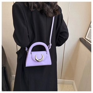 Detail of lavender mini crossbody bag featuring a silver crescent metal buckle and PU texture