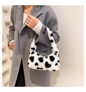 Detail shot of heart pattern faux fur handbag showing soft texture and compact size