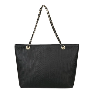 Minimalist black faux snake skin tote bag with gold chain shoulder strap on white backdrop